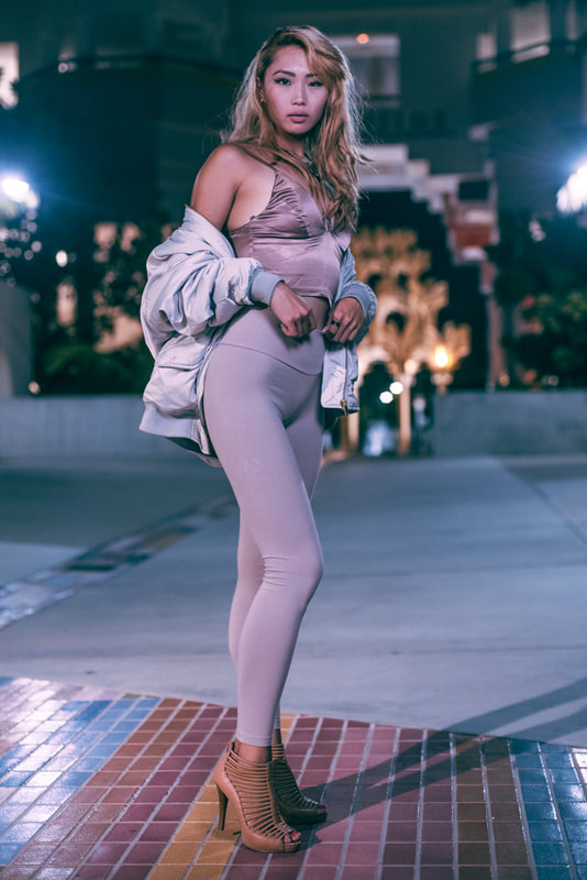 girl with heels and puffy jacket at night