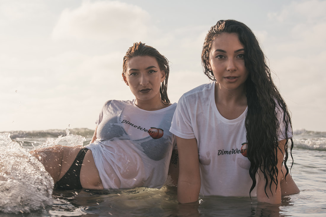 Two girls in the surf at the beach