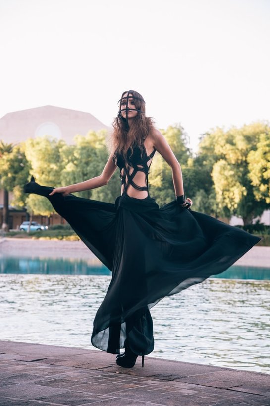 girl in black dress on a lake
